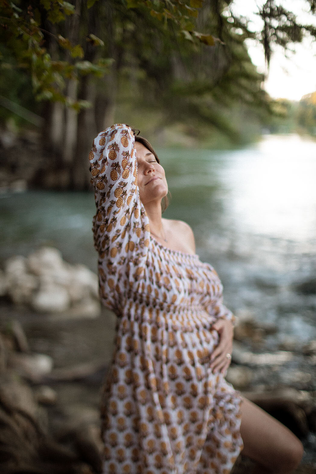 Maternity portrait of a pregnant woman standing in a river, photographed by San Antonio family photographer Sara James.