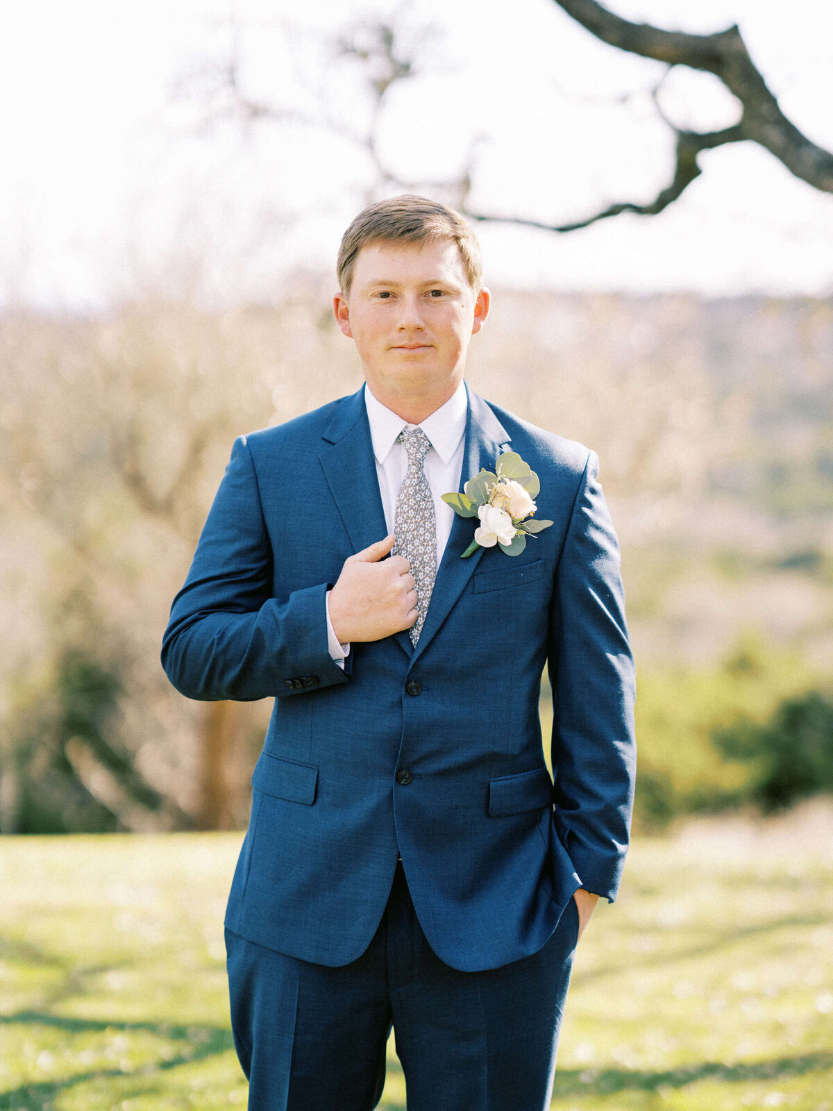 Canyonwood Ridge groom in navy suit with floral tie