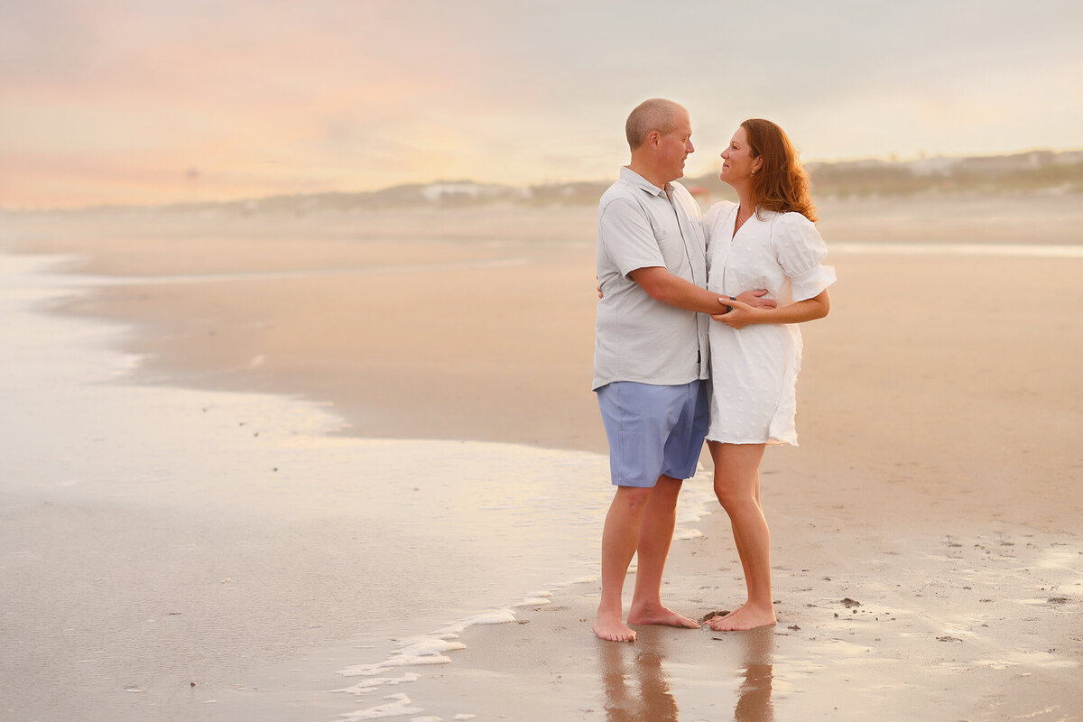 Couple embraces each other  during Family Pictures on Isle of Palms. 
