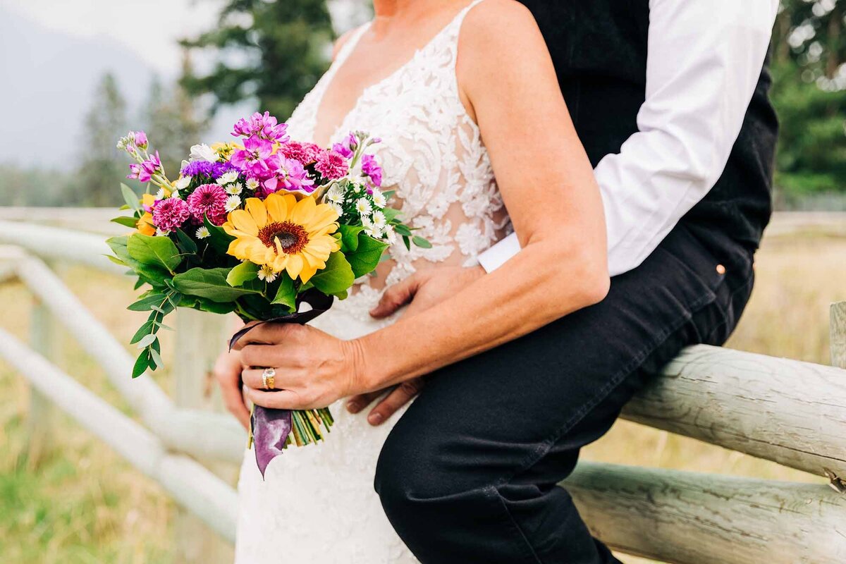 Close up of bride and groom with flower bouquet, The Silver Knot, Ronan, MT