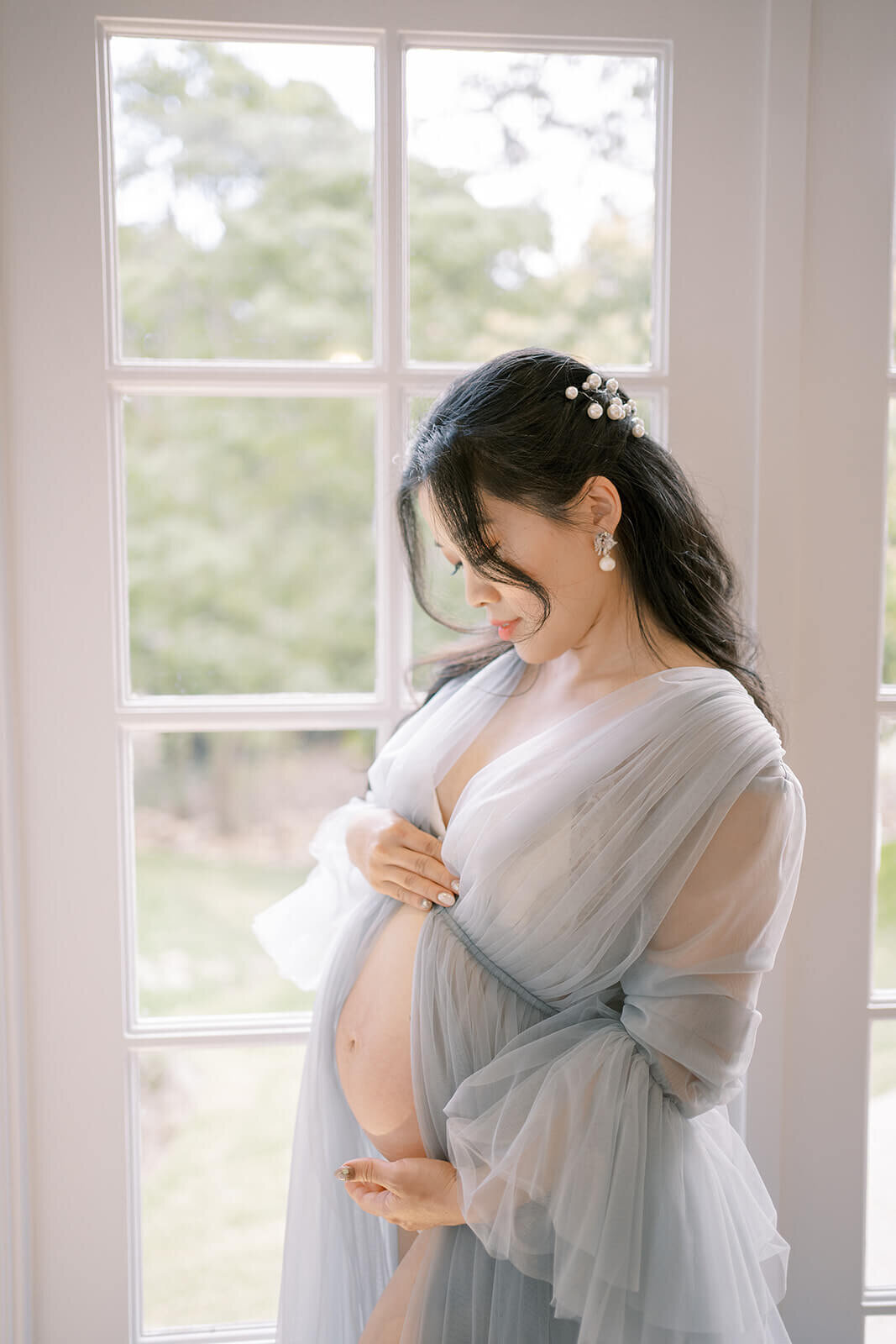Radiate in blue tulle elegance as a mum embraces the joy of pregnancy during a Gold Coast Kwila Lodge maternity photoshoot