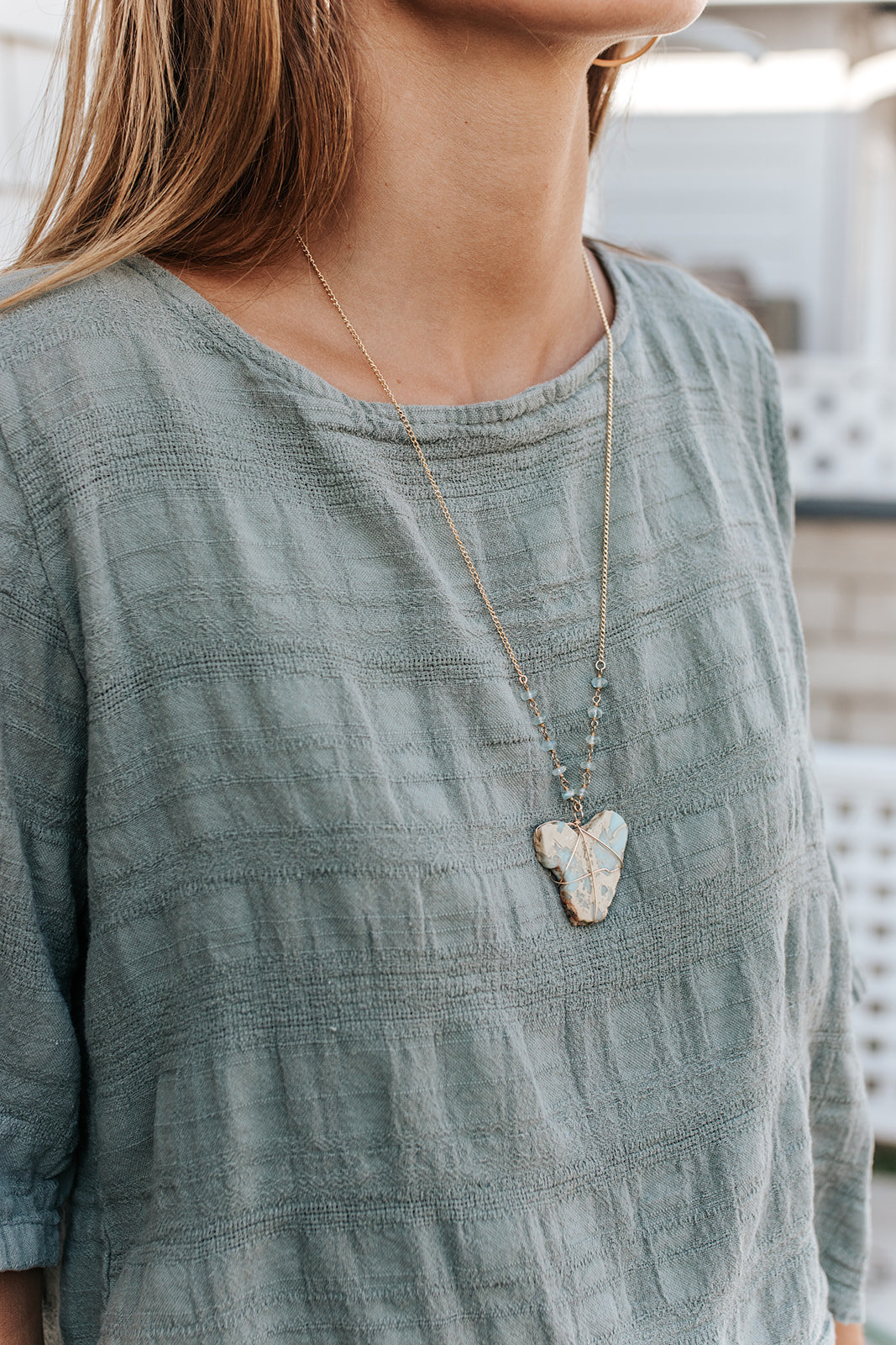 girl in sage top with stone necklace
