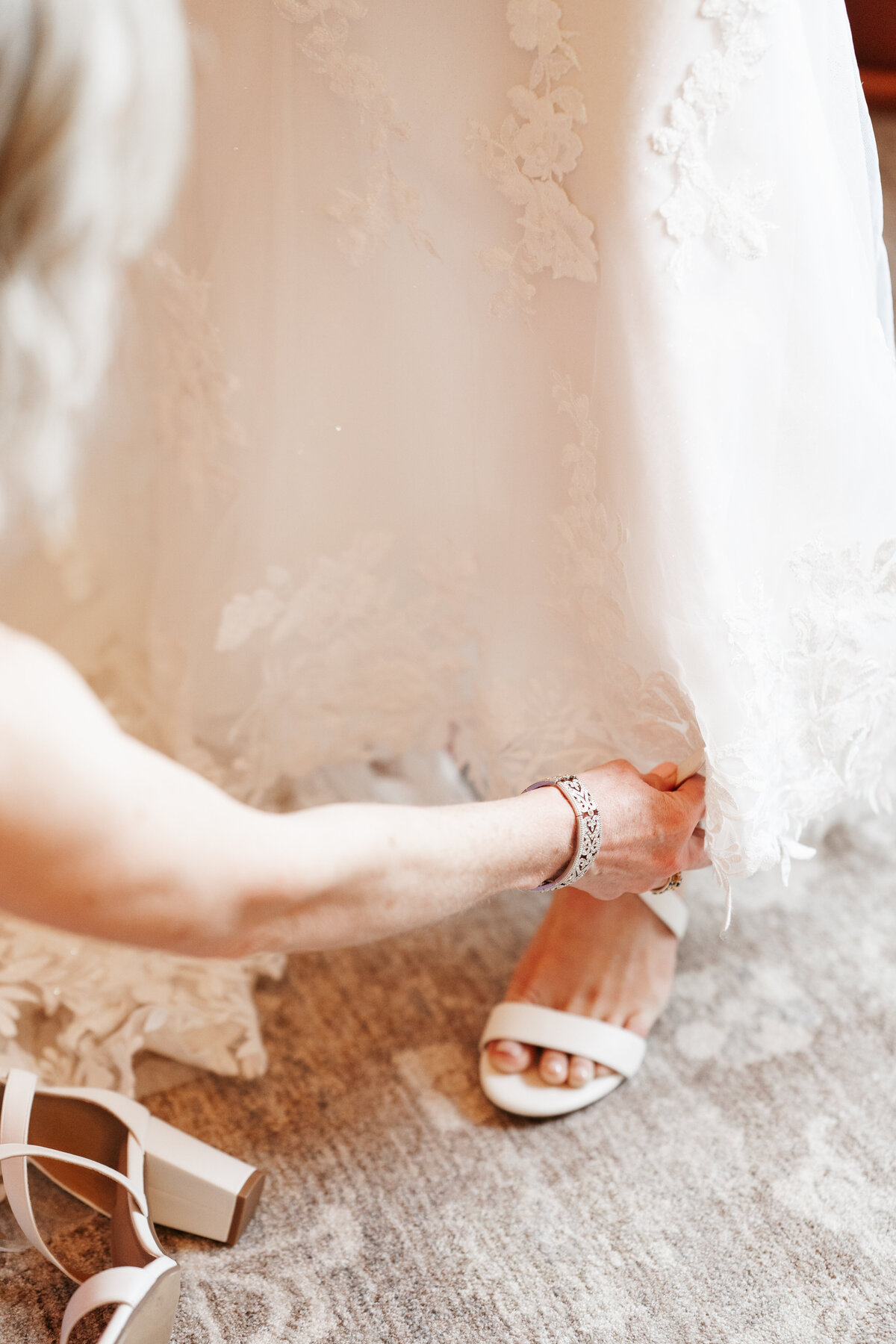 Bride getting ready with her bridesmaids on the morning of her wedding