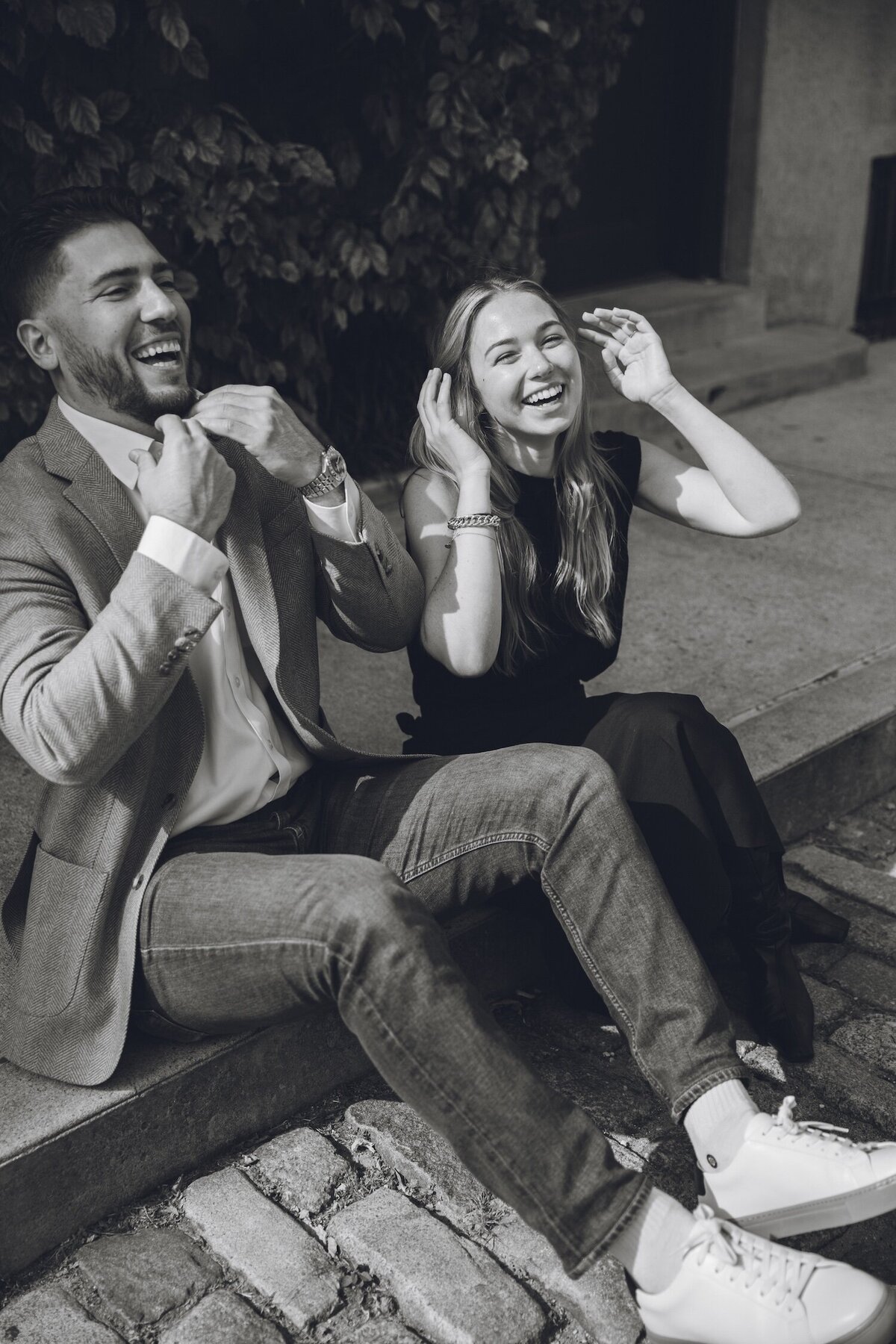 Couple laughing and celebrating together on the cobblestone street.