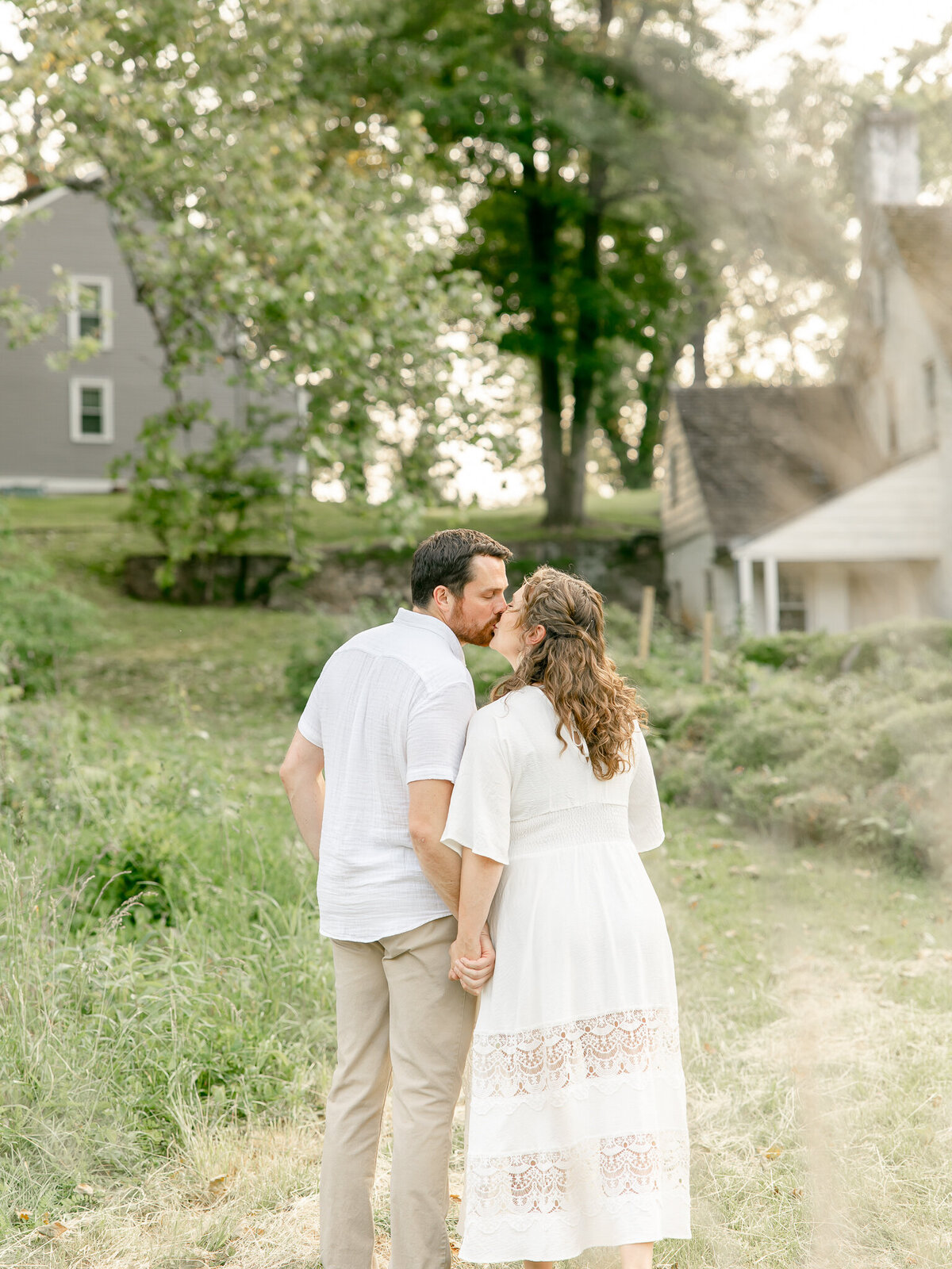 back view of a couple kissing during maternity session