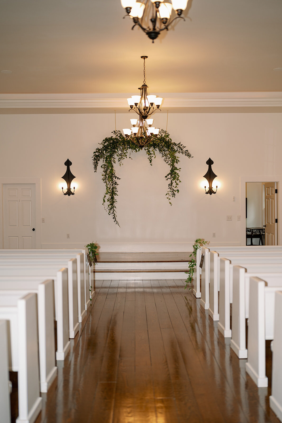 Elegant empty wedding chapel with greenery installation at The Morris Estate in Niles Michigan, classic ceremony detail photo.