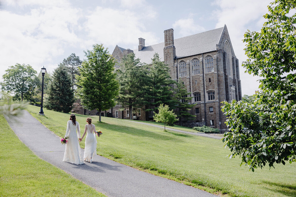 Brides walking along  at Cornell University wedding