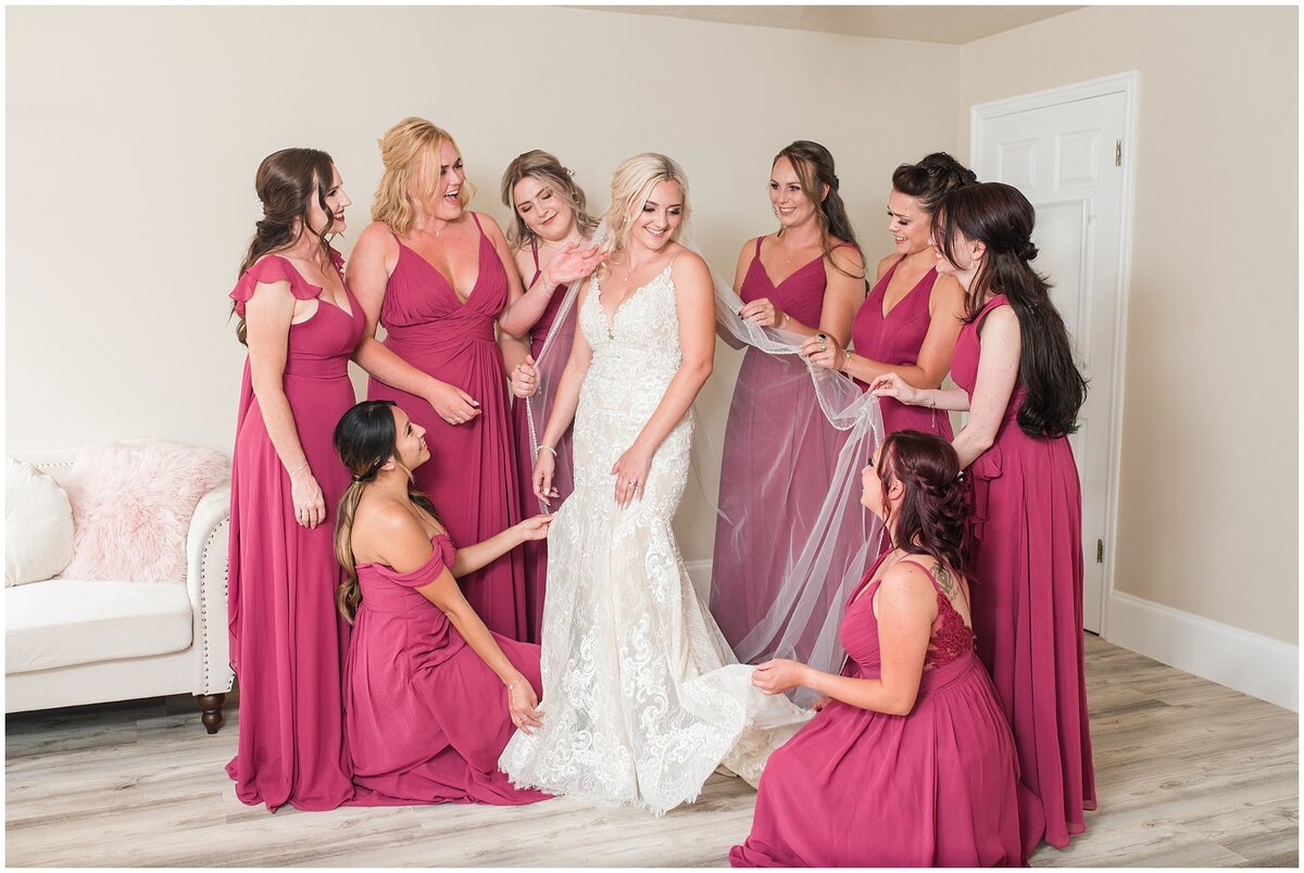 Bridesmaids helping bride get ready at Oak Hills Reception and Event Center
