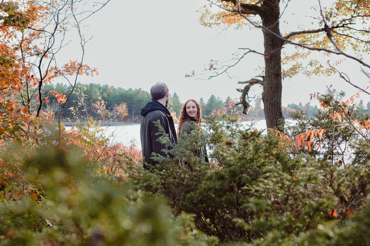 engaged-couple-walking-in-nature-at-little-mellon-lake-ontario-1