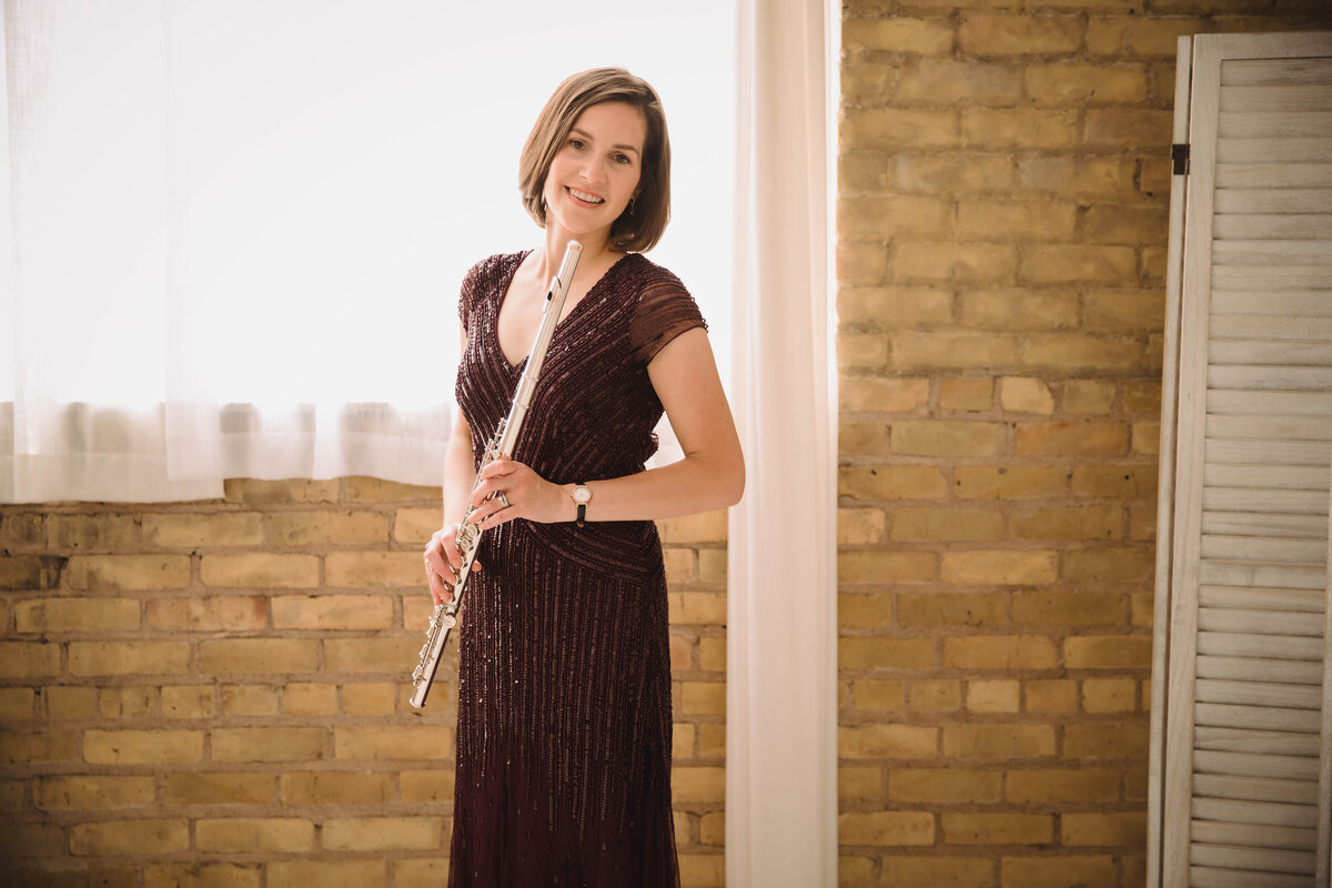 Twin Cities Flutist & Teaching Artist Sarah Weisbrod Standing & Holding Flute