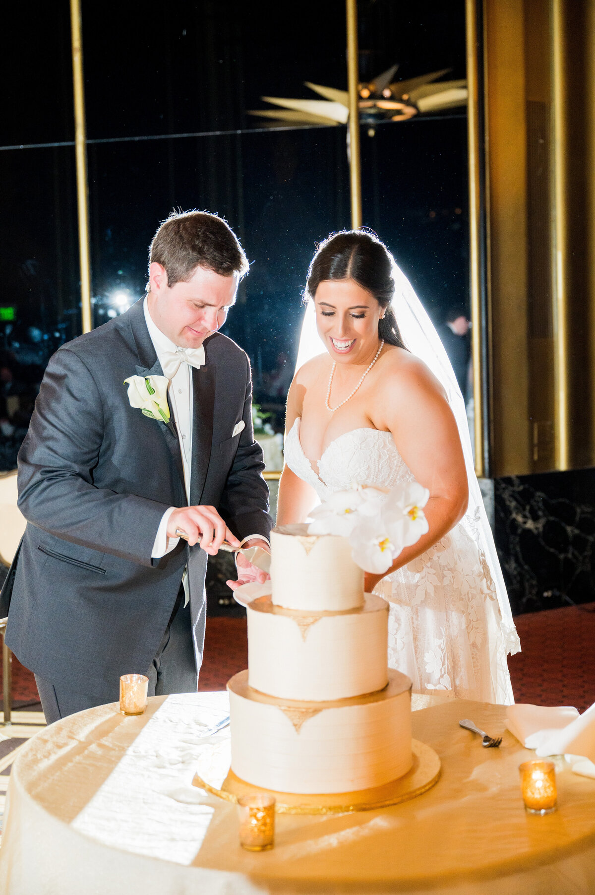 bride and groom cutting their wedding cake during their urban room wedding reception