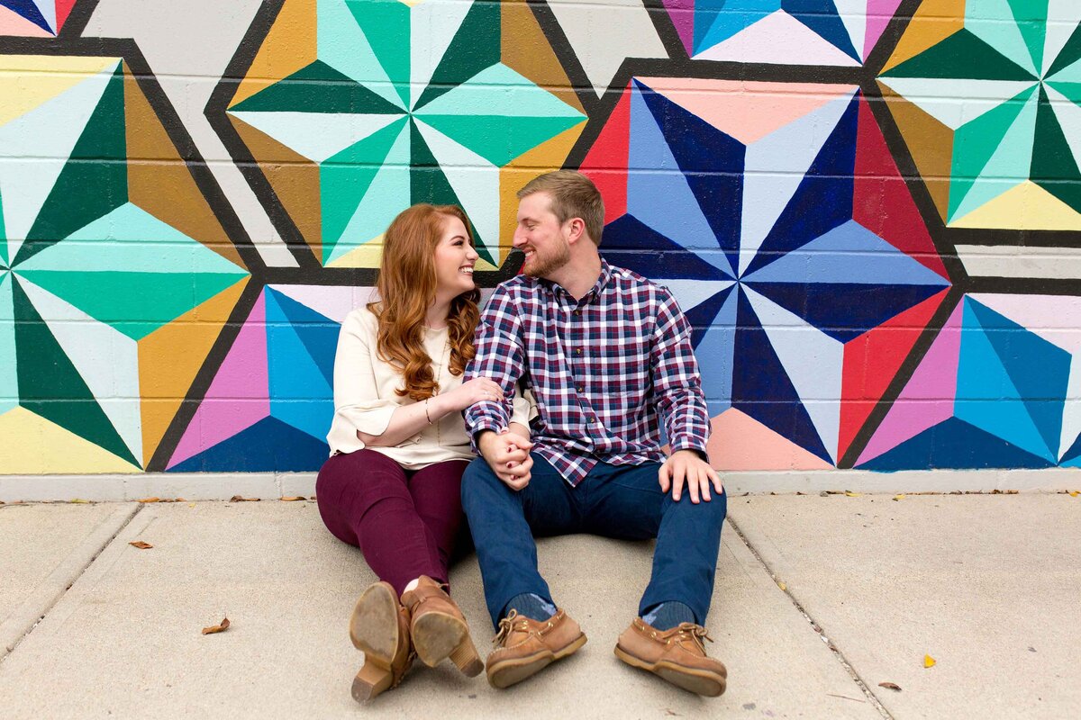 Couple posing in front of colorful wall