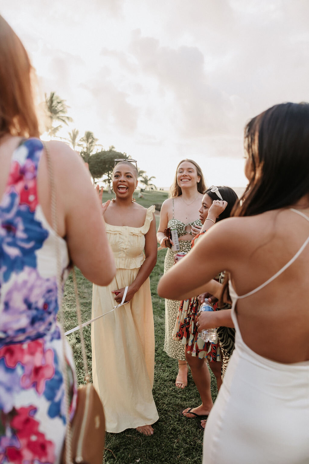 guests in colorful dresses laughing at the park