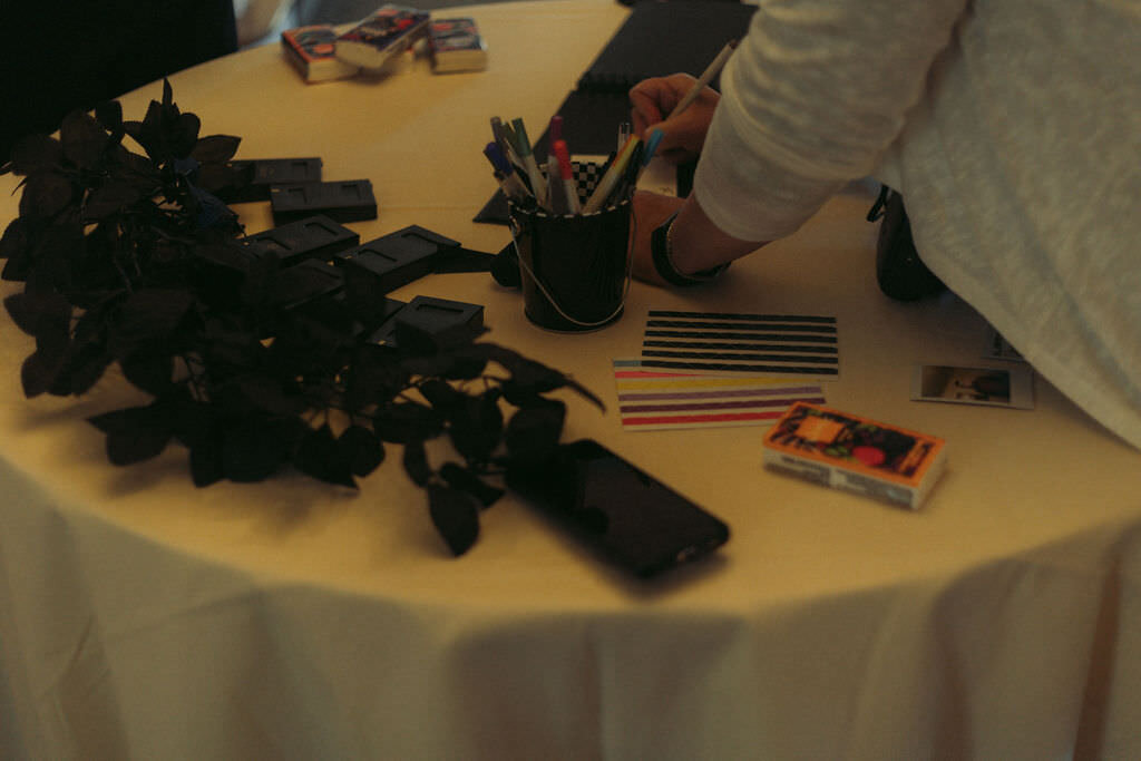 Flowers and pens laying on a table.