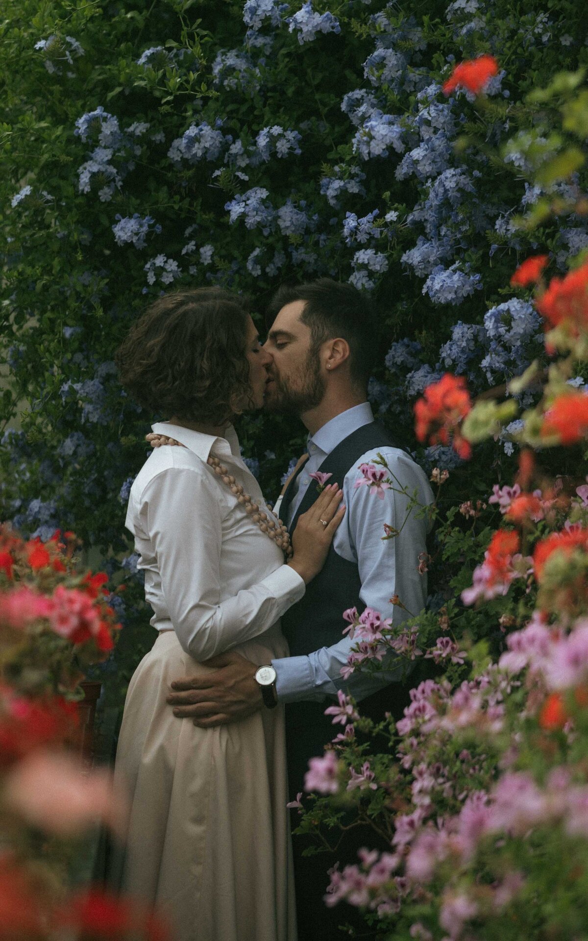 Capture the intimate and serene moments of a couple in a lush greenhouse, surrounded by vibrant greenery. A perfect setting for timeless and romantic wedding photography