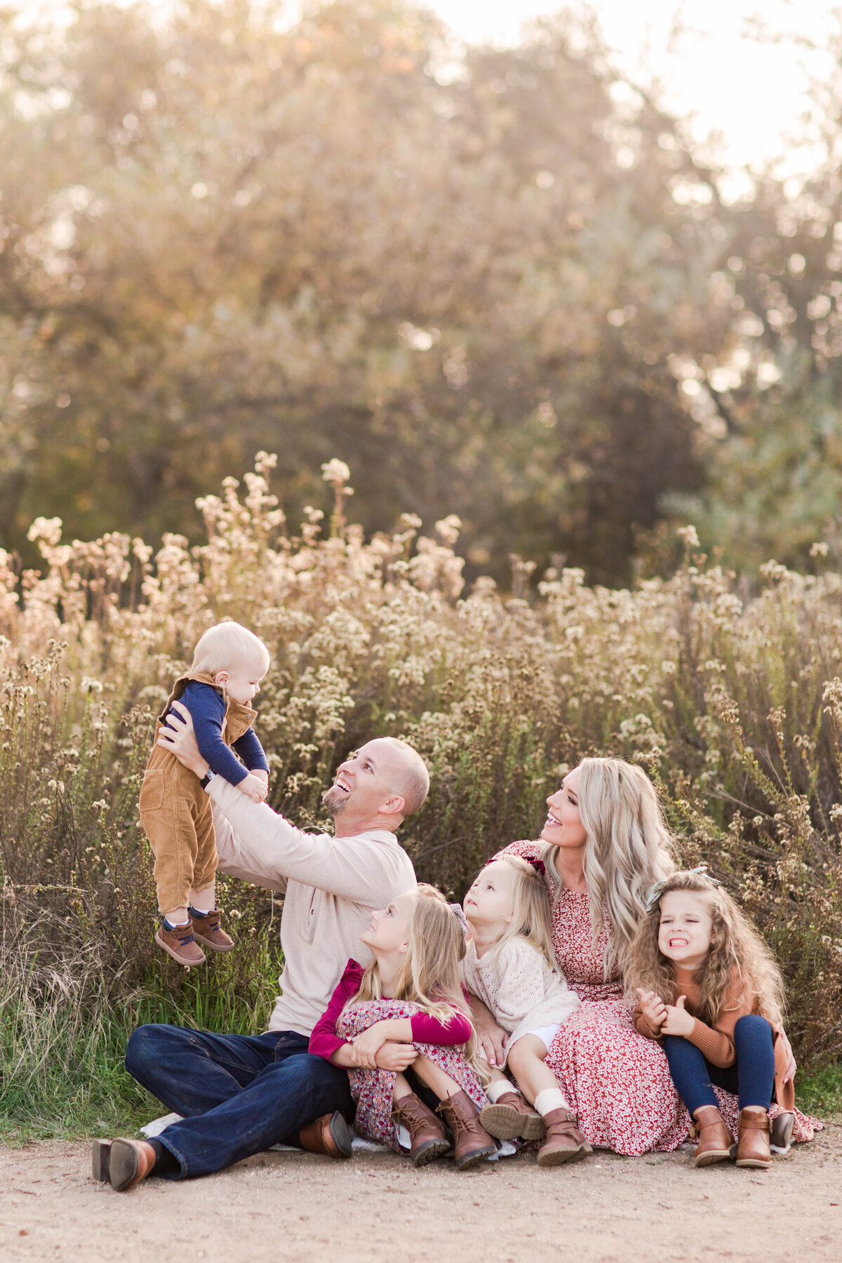 Sweetwater-River-Bridge-Photoshoot-sitting-in-grassy-field