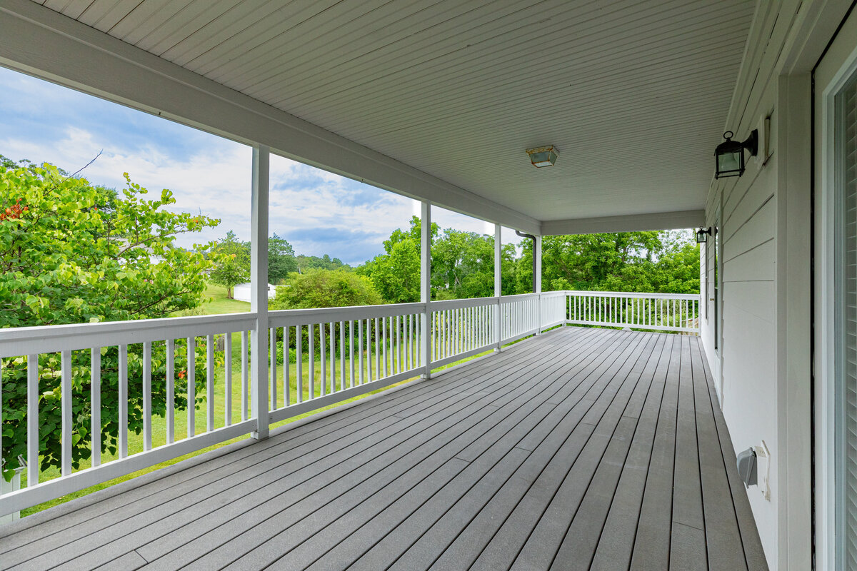 A view from a porch bult with grey composite and white PVC railings built by a Worcester & Central MA Porch Contractor