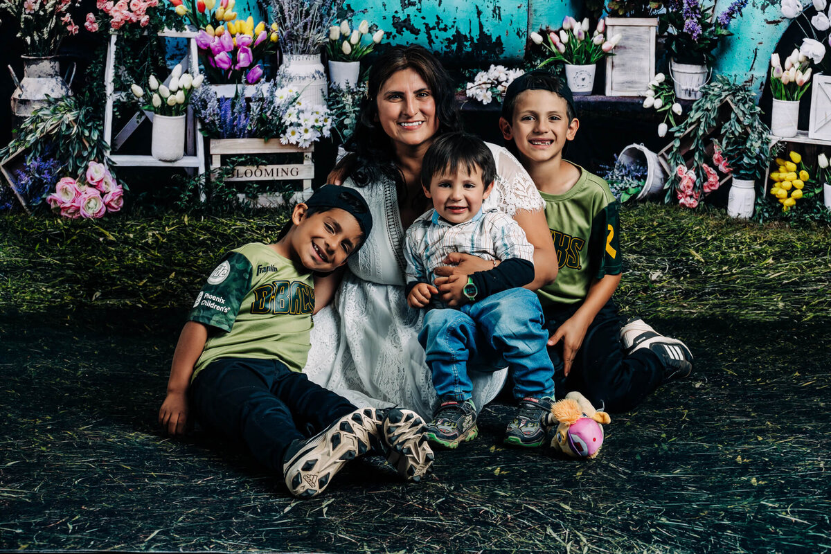 Mom poses with sons in front of vintage truck in Prescott family photos