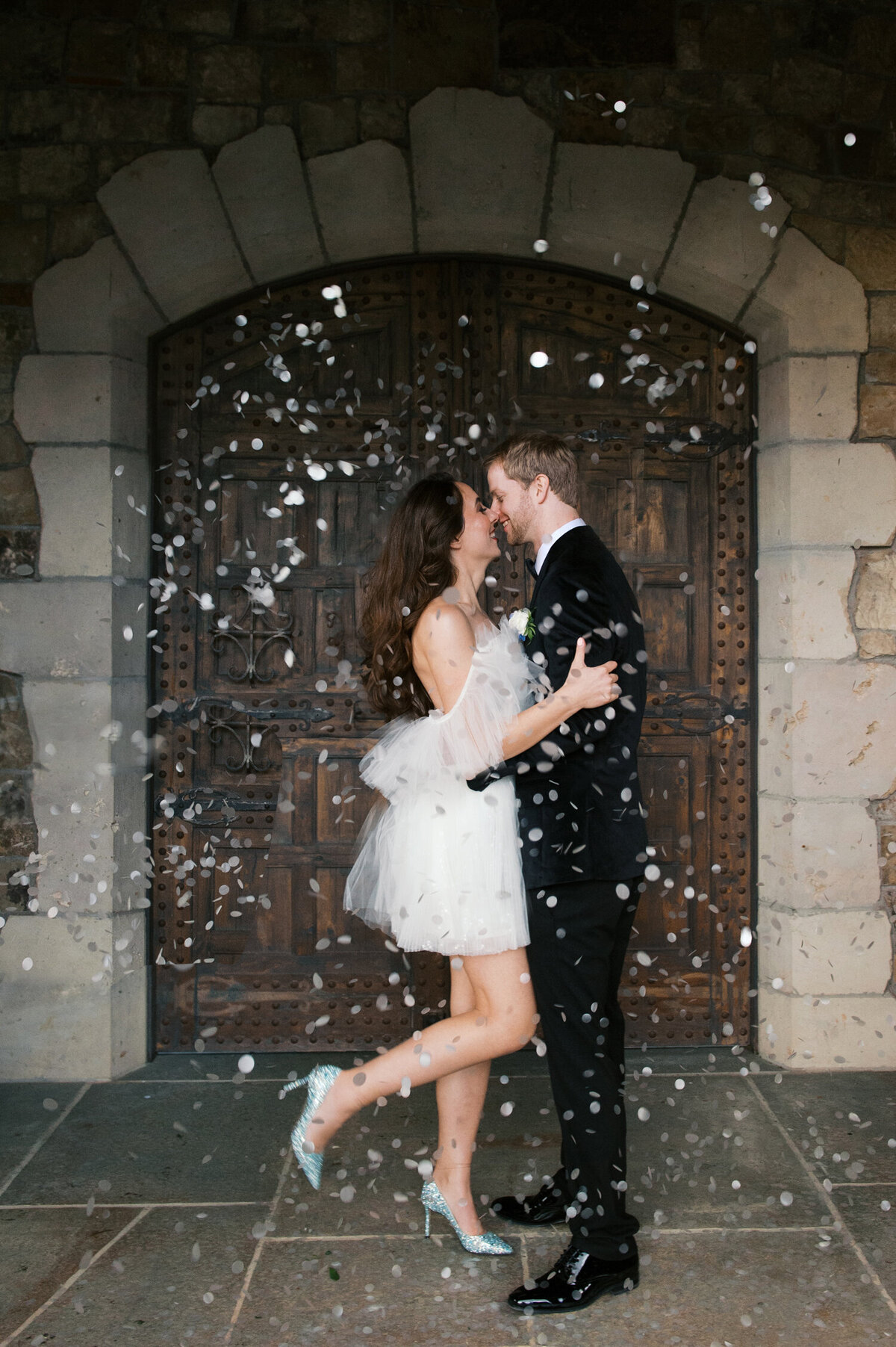 luxury oregon couple during their grand exit at chateau de lis with tossed confetti
