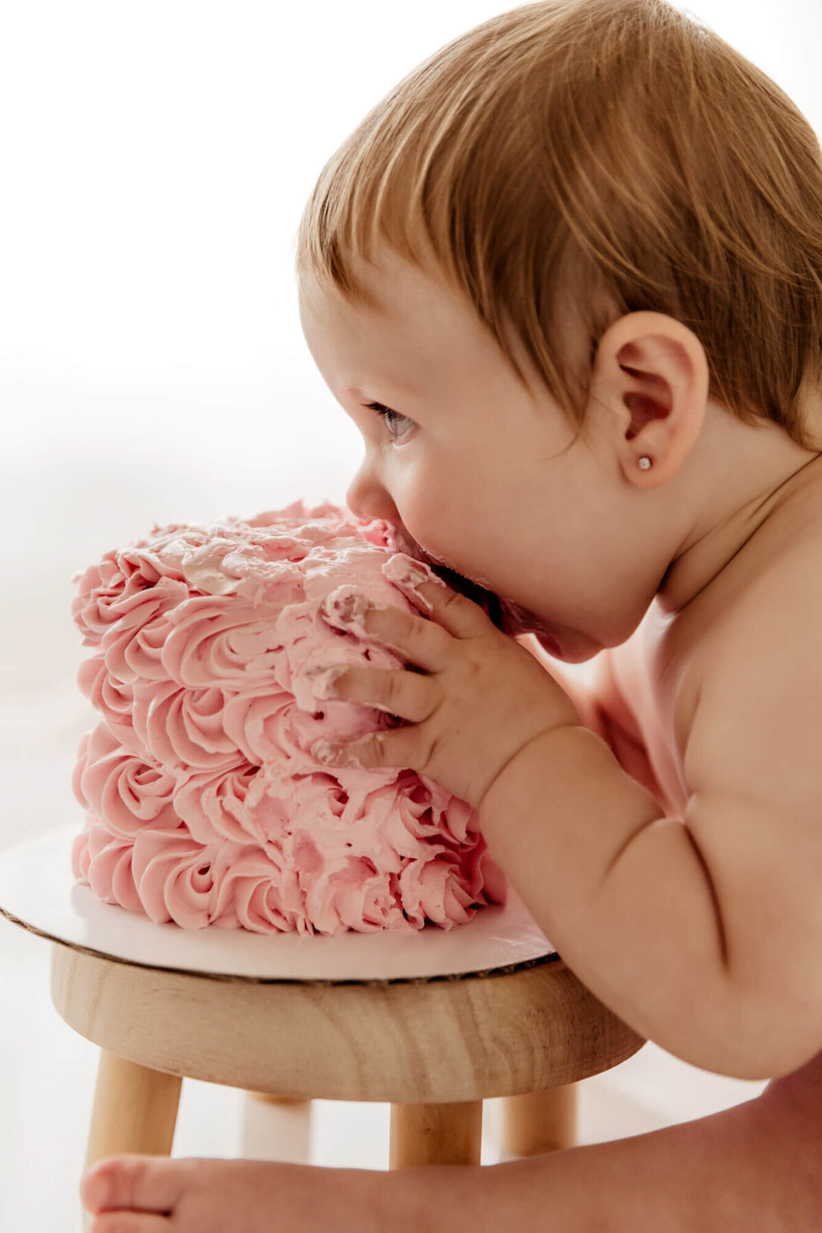 Girl takes a bite of her cake during a cake smash in OKC.