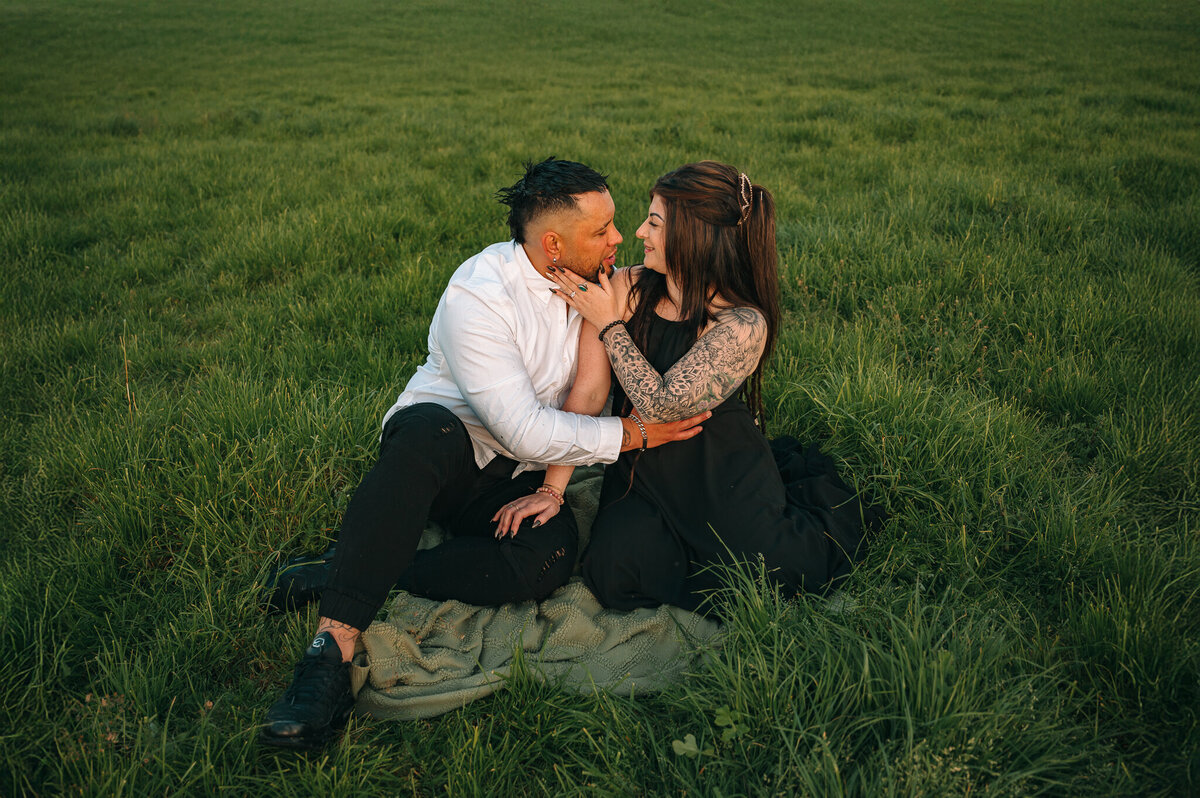 couple sitting ina feild about to kiss-1