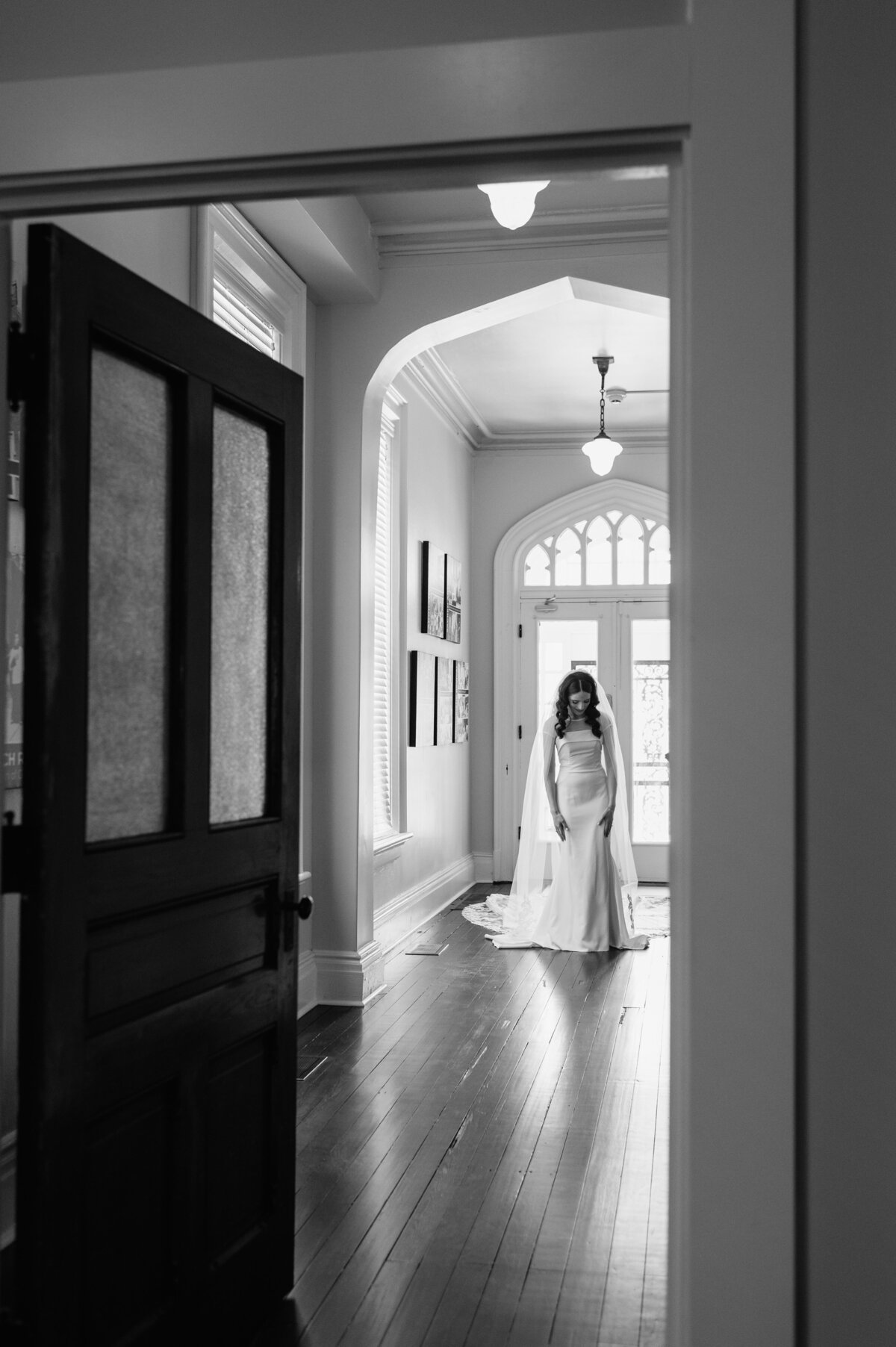 Bride walking through black and white entryway photo