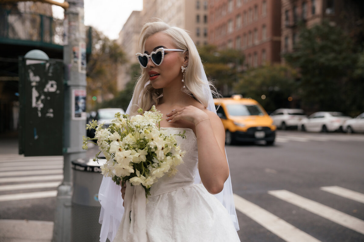 Close-up shot of the bride’s bouquet with NYC streets softly blurred in the background.