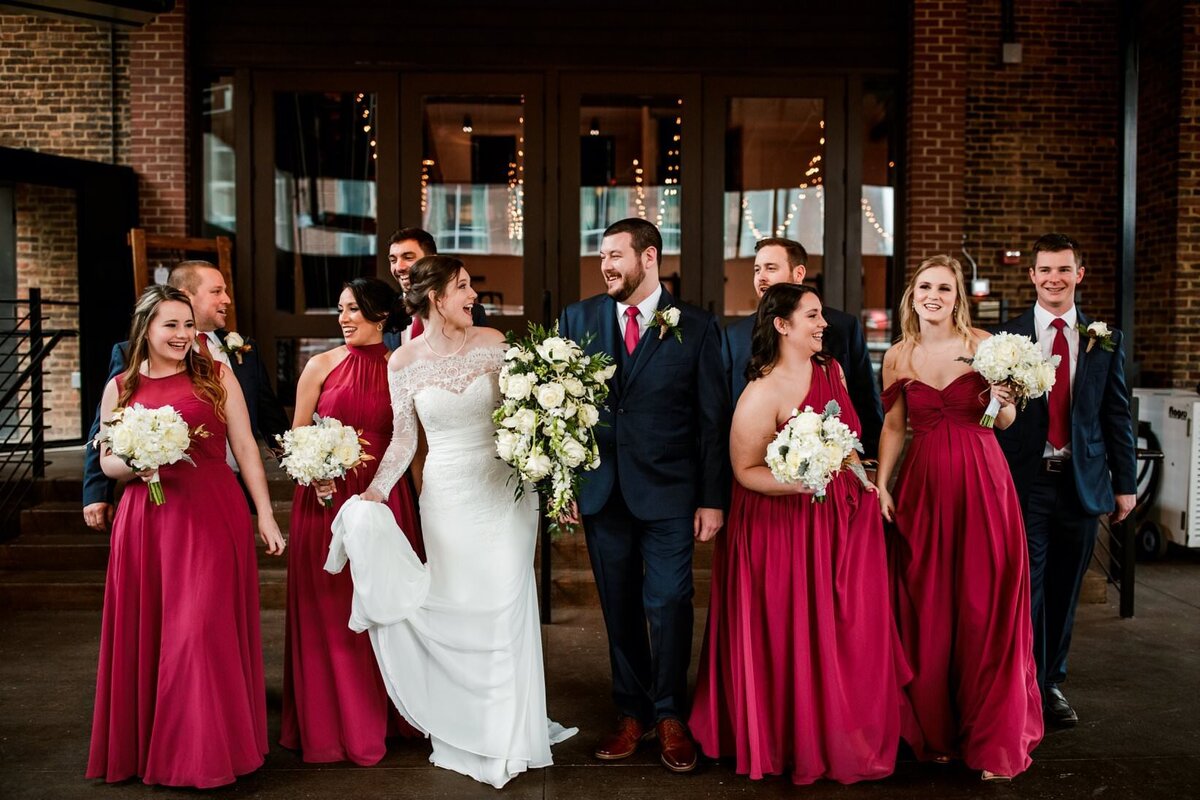Bridal party walking outside of The Bell Tower
