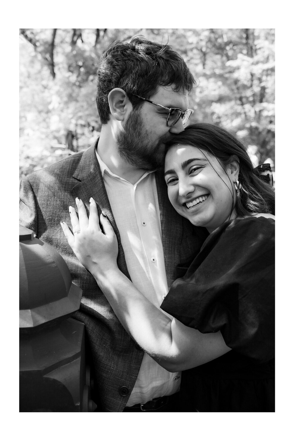 black and white image of a straight mixed race couple posing during an engagement session