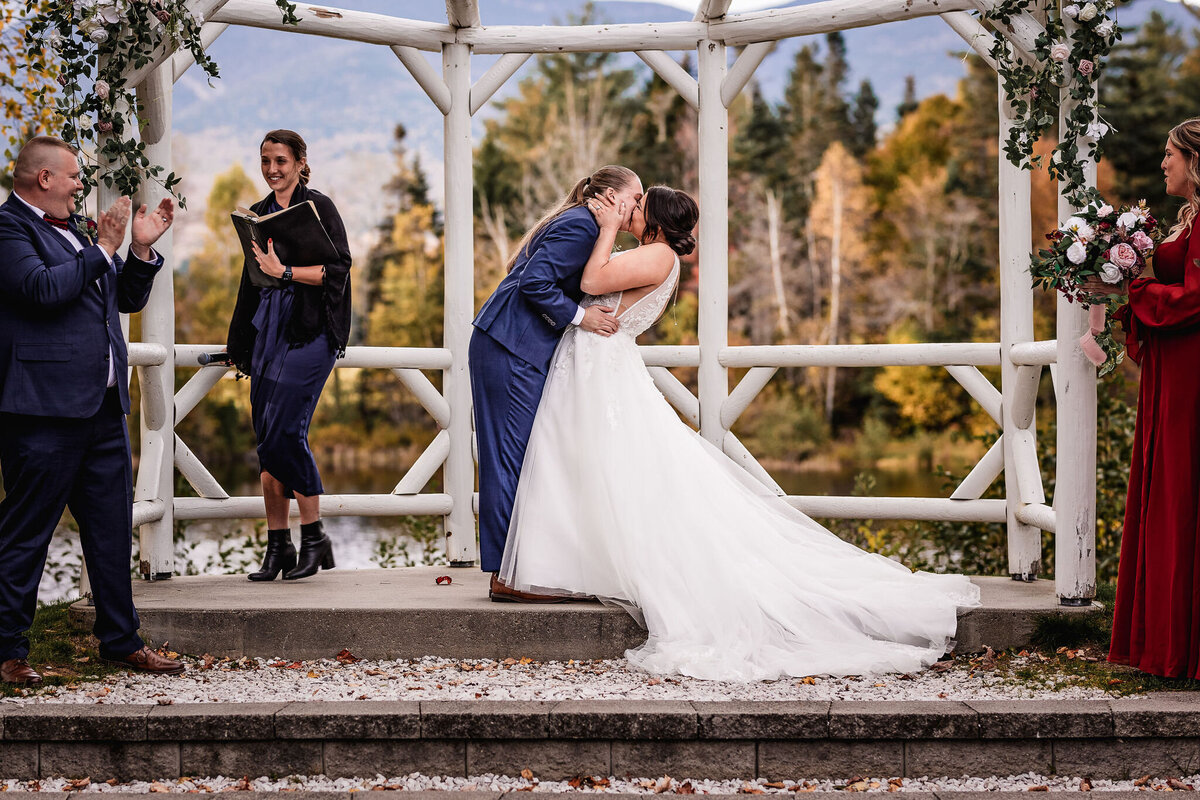 Couple kissing during wedding ceremony at Fall wedding at Waterville Valley Resort by Lisa Smith Photography