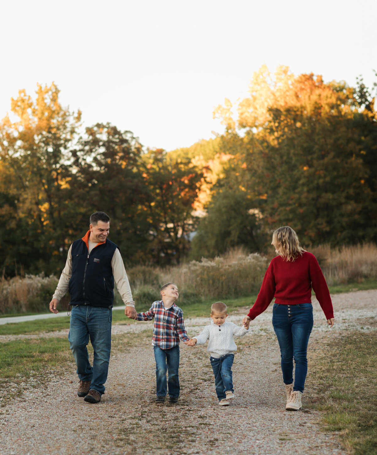 mom dad and two sons walking in park for family photos cleveland family photography