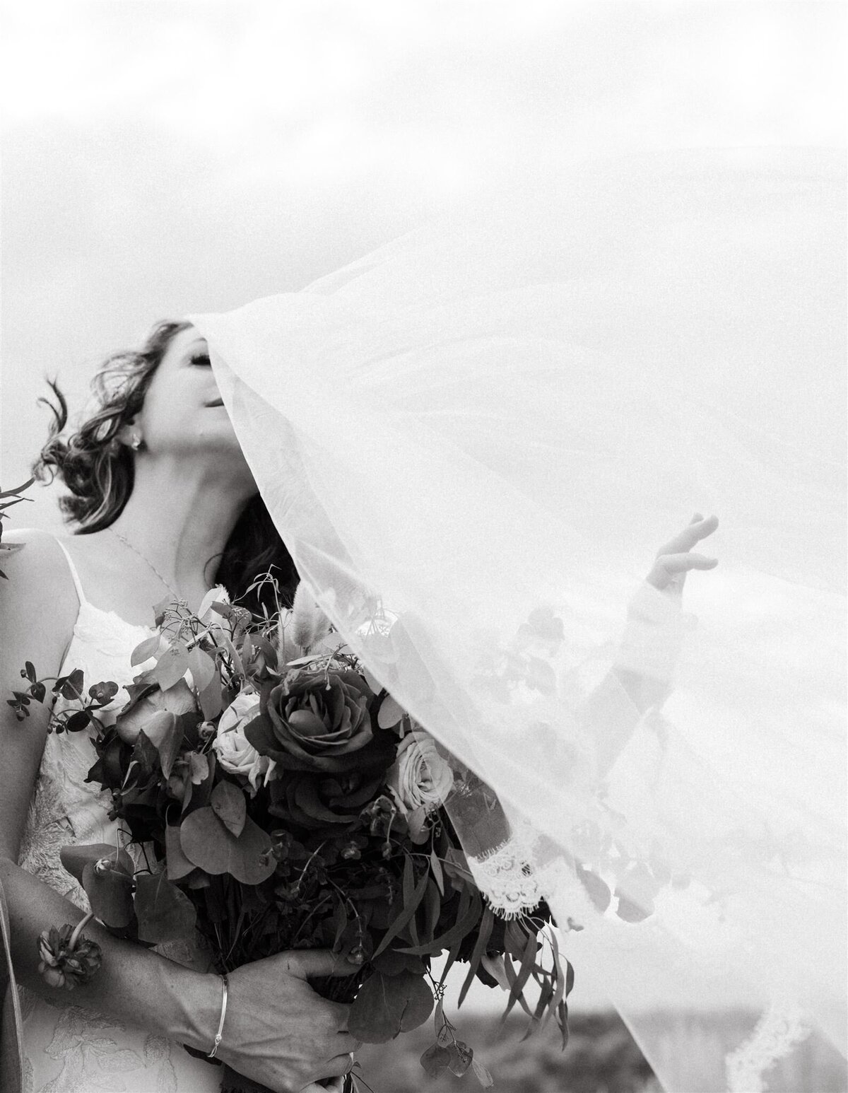 a bride with a veil flowing in the wind