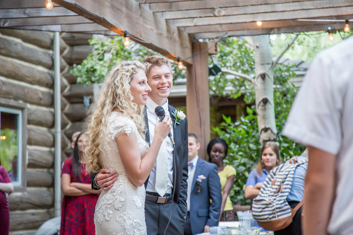 a bride and groom thank guests at their mountain wedding reception