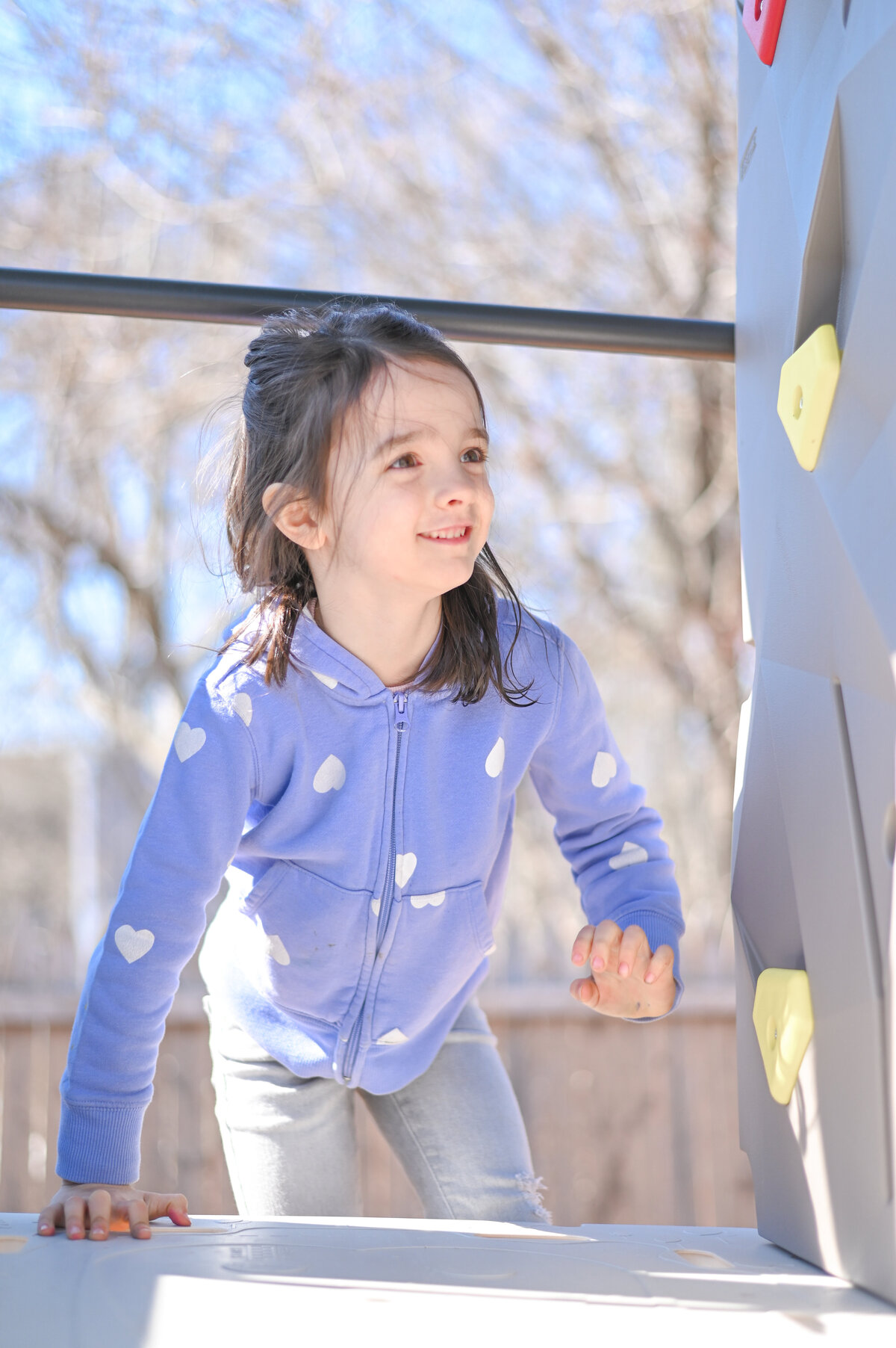 Student playing on the playground House of Parker Preschool Gorham Maine
