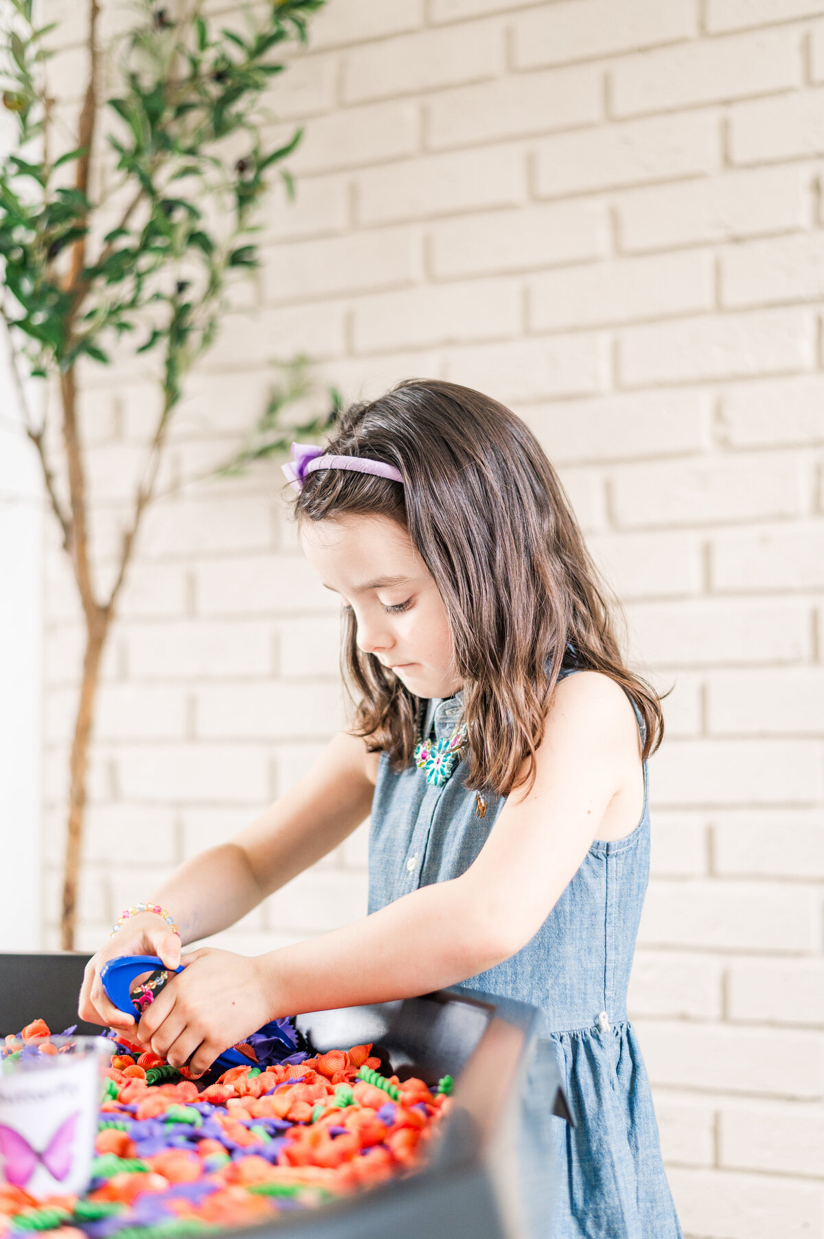 Student engaging in playful craft at House of Parker Preschool Gorham Maine