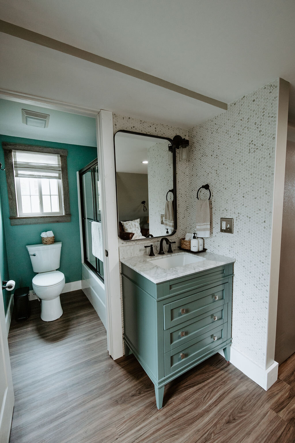 the sage green vanity with marble top and penny tiled wall in the cottage overnight suite at Willowbrook wedding venue in PIttsburgh