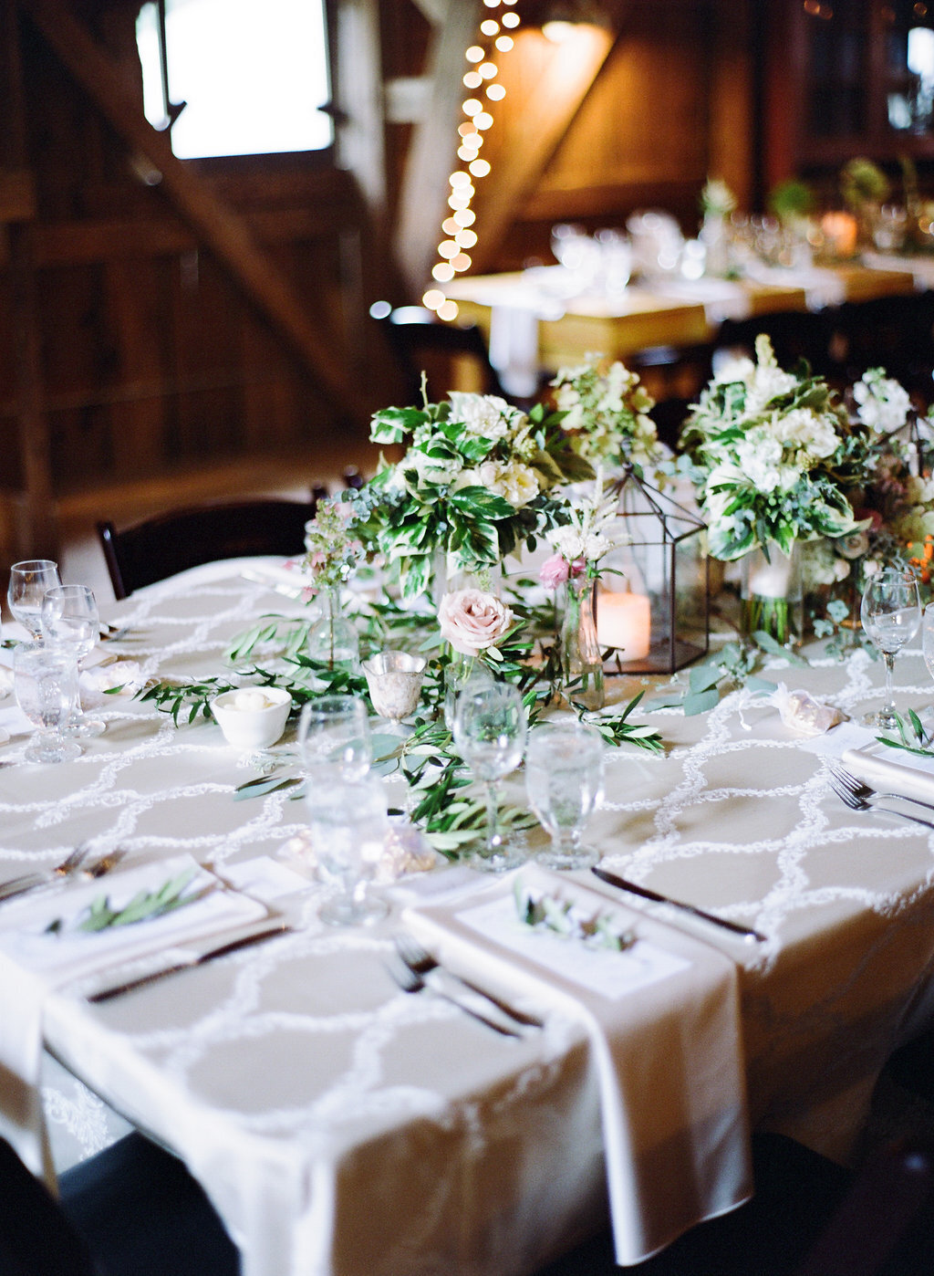 Centerpiece and table settings for a classic green and white wedding