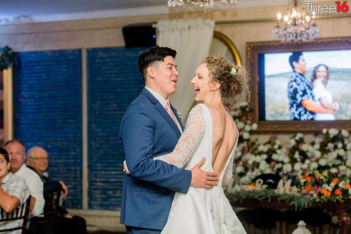 Bride and Groom laugh during the first dance