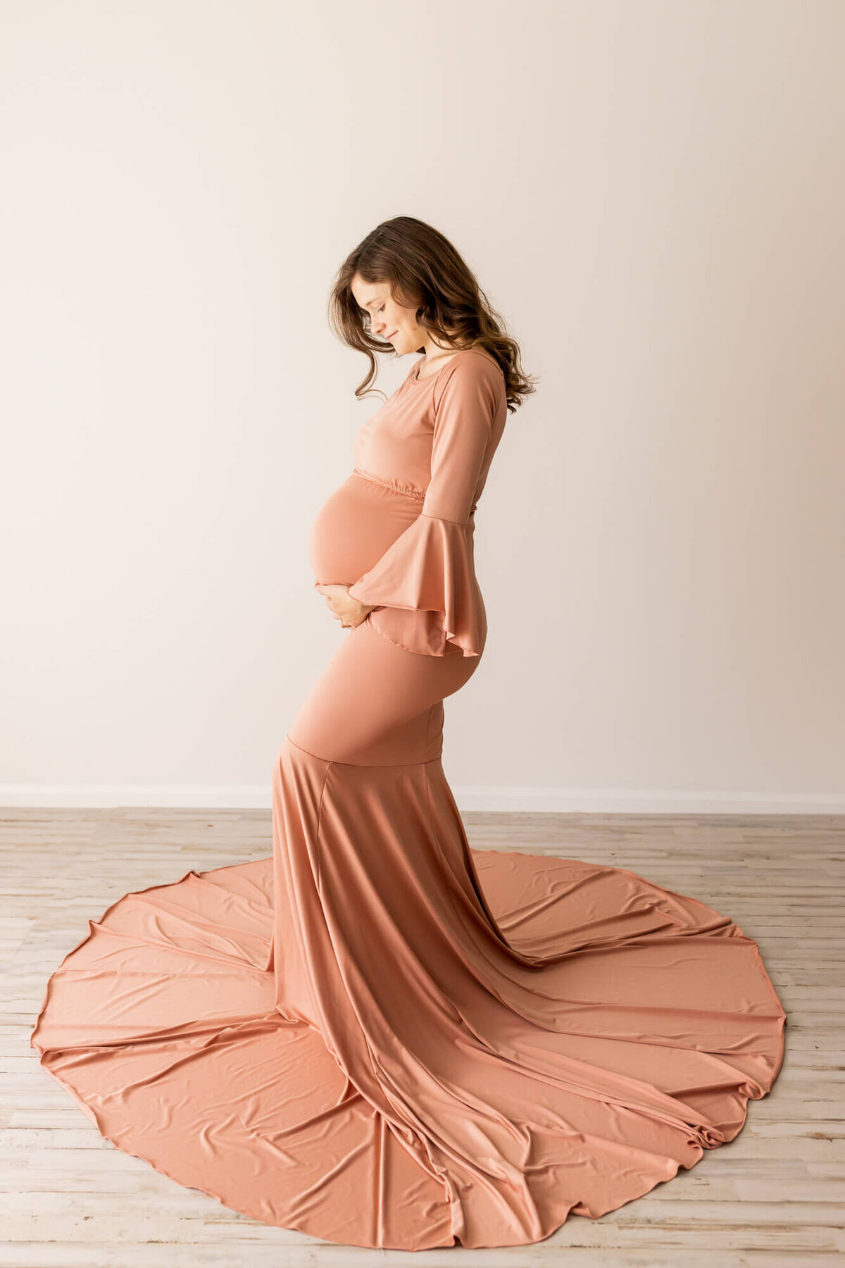 Mom to be in a rose gold maternity dress