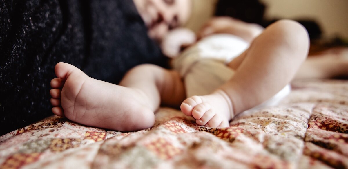 a closeup of a newborn baby girl's feet
