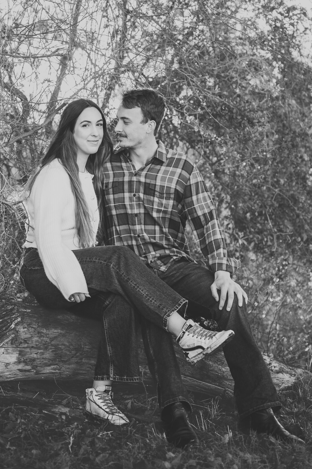 Black and white photo of a couple sitting together outdoors — emotive lifestyle photography in Dallas–Fort Worth by Poppy + Blue Photography
