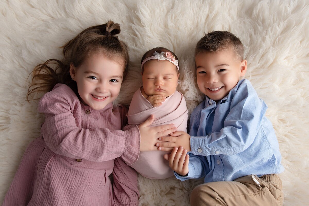 brother and sister with newborn baby