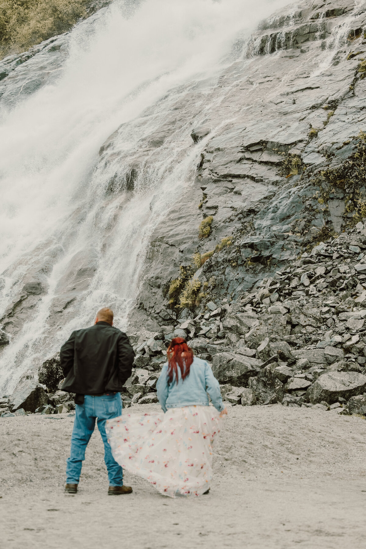 couple dancing by the waterfall