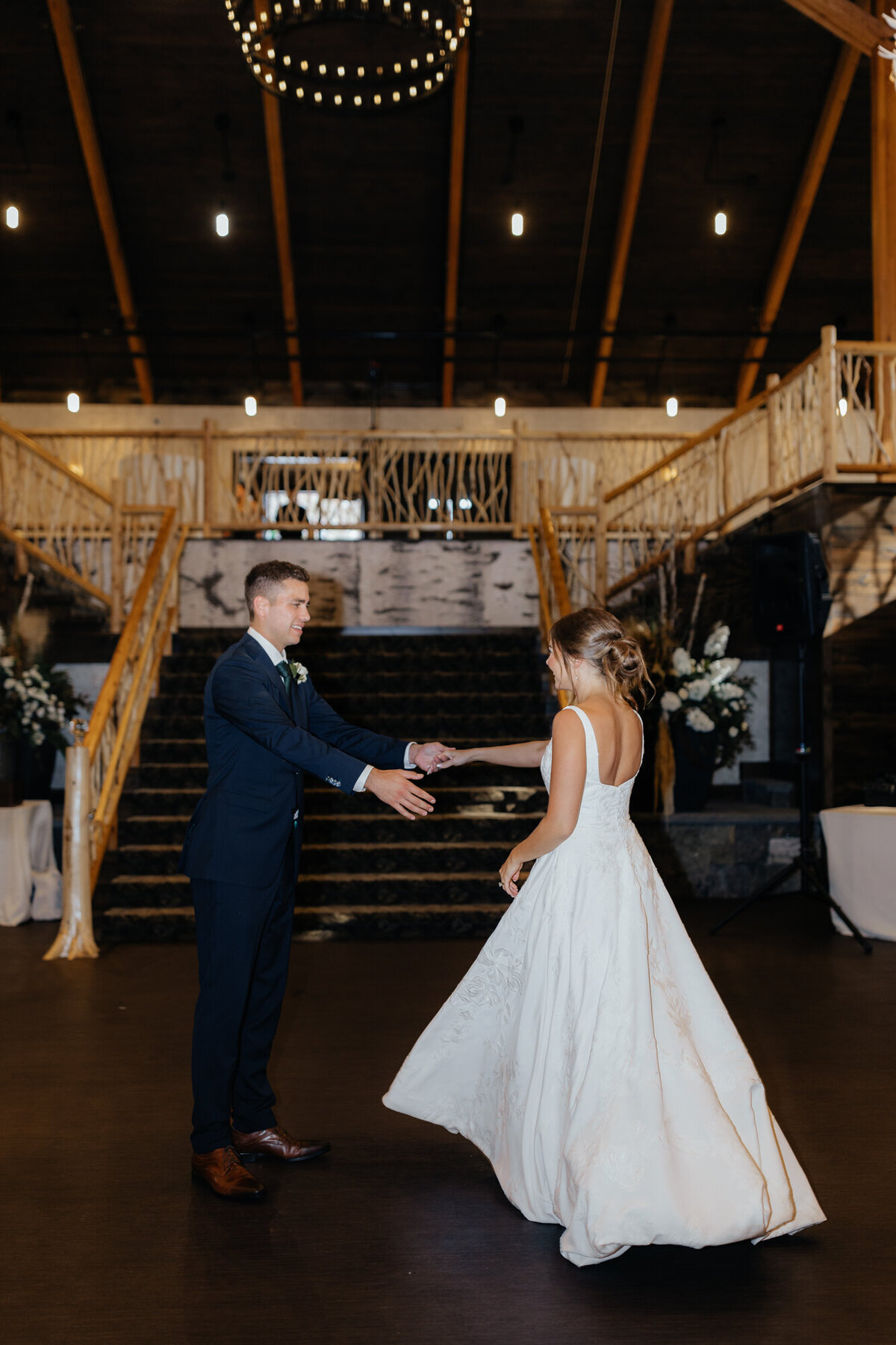 Dance floor packed with guests under warm lighting and rustic decor