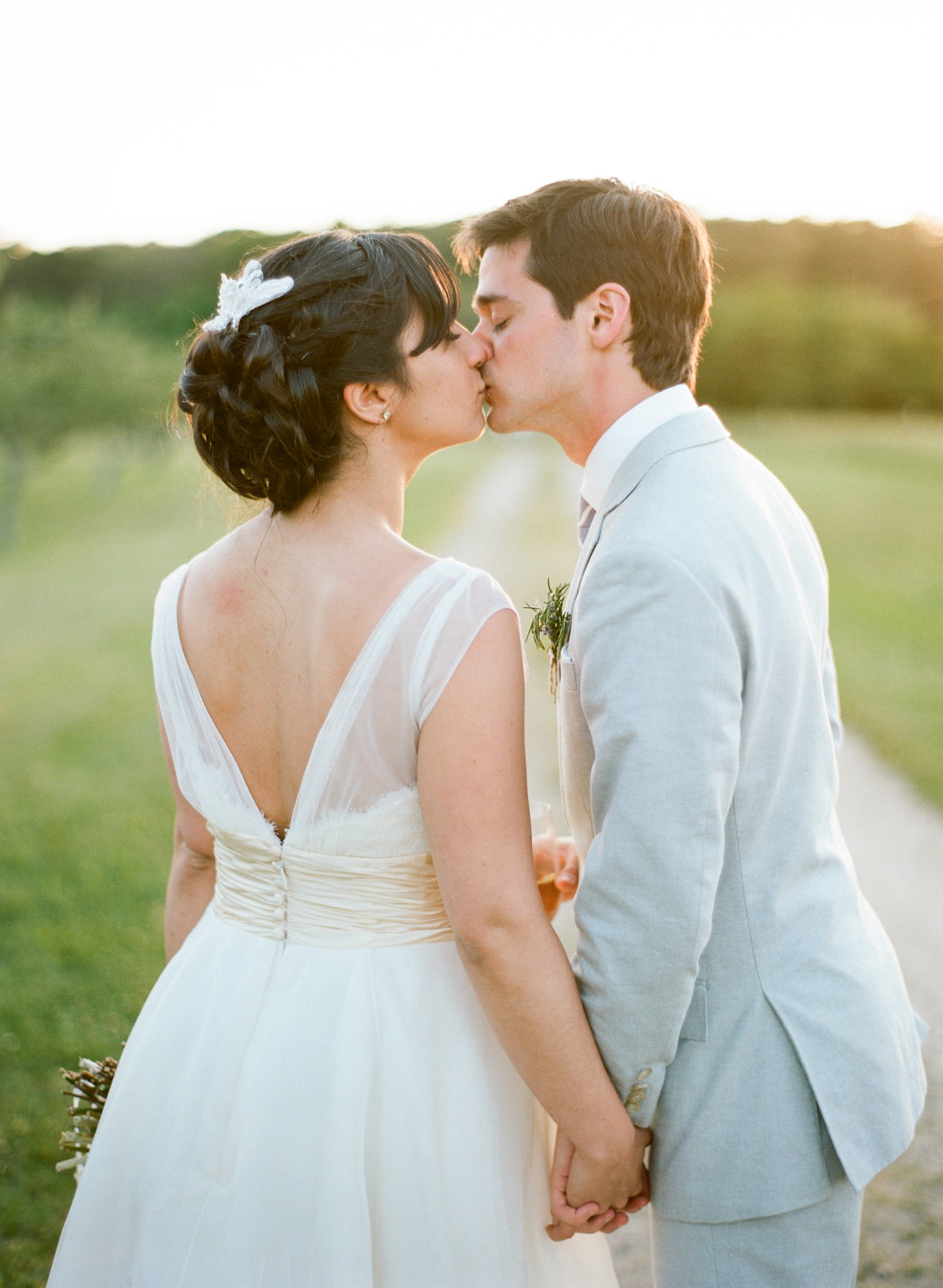 Bride and groom kiss golden hour