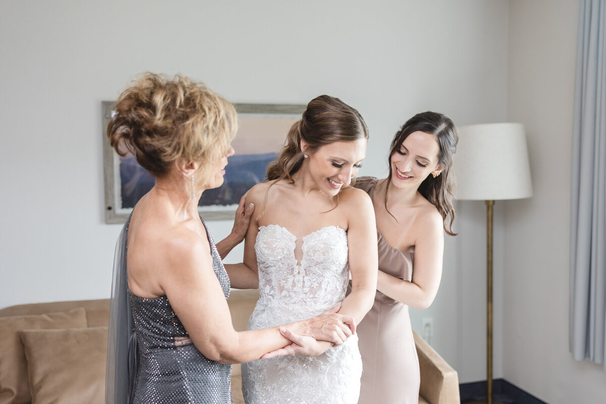 A bride gets ready with her mother and sister. for her black tie wedding