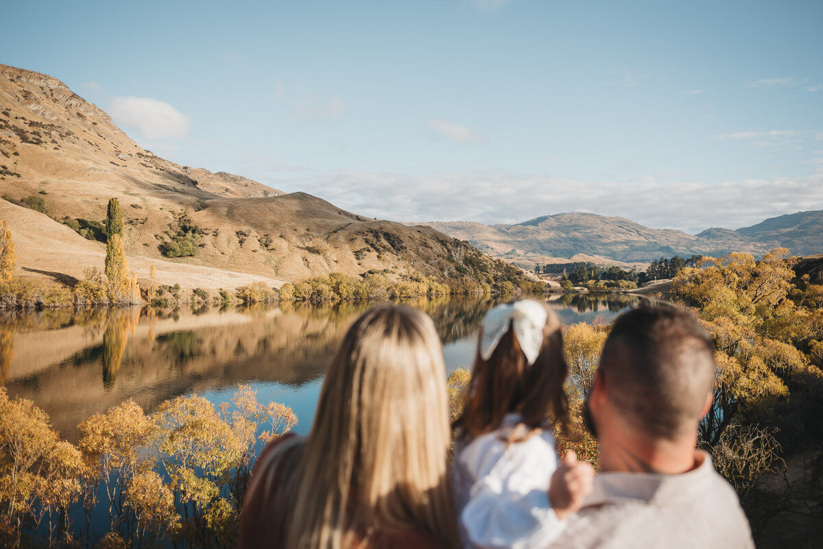 a family looking at the lake during a Queenstown family photography session captured by Bie