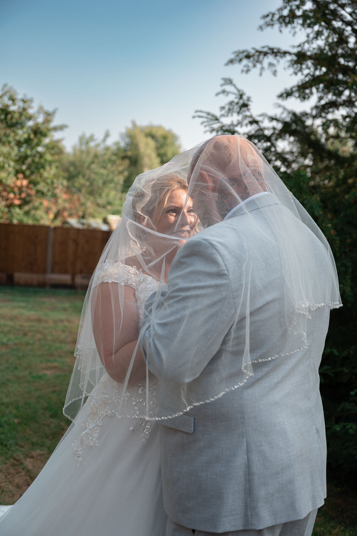 Bride and groom embracing in garden during golden hour portraits – Cheshire Wedding Photographer