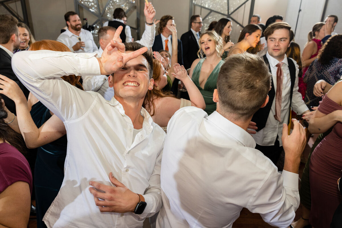 A group of people are dancing at a wedding reception