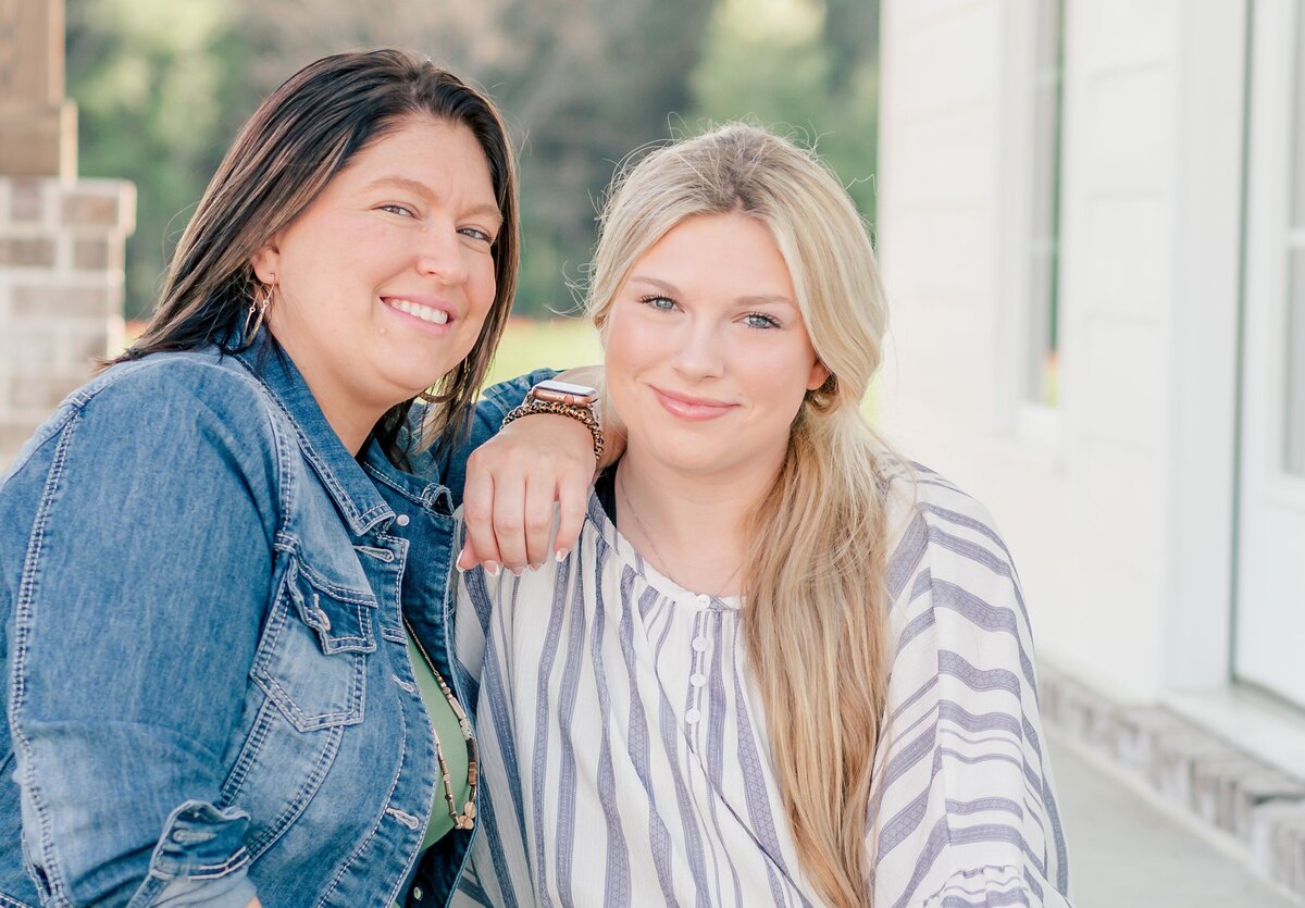 older sister leaning on younger sister during their sister  photoshoot 